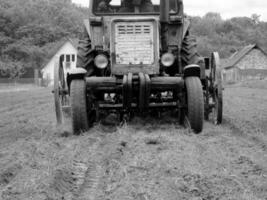 Plowed field by tractor in black soil on open countryside nature photo