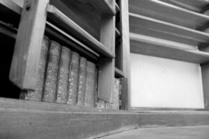 Personal library consisting of big empty bookcase with wooden bookshelf for books photo