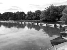 Photo on theme old wooden boat on green water of pond