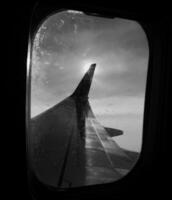 Beautiful view from airplane window, large wing of aircraft shows casement photo