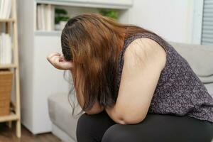 Sad Overweight plus size woman thinking about problems on sofa upset girl feeling lonely and sad from bad relationship or Depressed woman disorder mental health photo