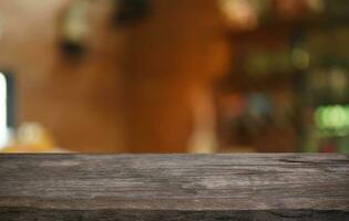 Mock up for space. Empty dark wooden table in front of abstract blurred bokeh background of restaurant . can be used for display or montage your product photo