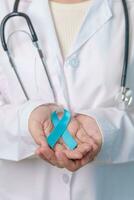 Blue November Prostate Cancer Awareness month, Doctor with Blue Ribbon in hospital for support people life and illness. Healthcare, International men, Father, Diabetes and World cancer day photo