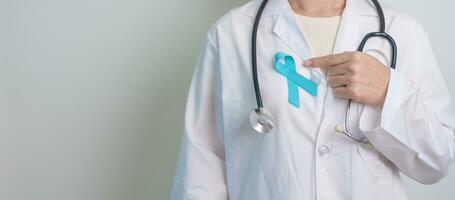 Blue November Prostate Cancer Awareness month, Doctor with Blue Ribbon in hospital for support people life and illness. Healthcare, International men, Father, Diabetes and World cancer day photo