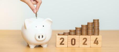 Happy New Year with piggy bank and flipping 2023 change to 2024 block. Resolution, Goals, Plan, Action, Money Saving, Retirement fund, Pension, Investment and Financial concept photo