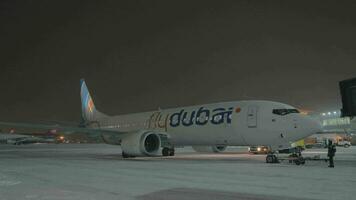 Parked Boeing 737 MAX-8 FlyDubai in Sheremetyevo Airport at winter night video