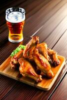 Grilled chicken wings with a glass of beer on a wooden table. AI Generative photo