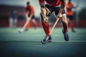 A male hockey player is playing field hockey photo