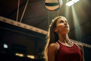 Female volleyball players are competing on the indoor volleyball court photo