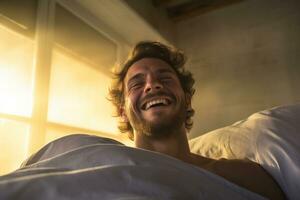 A man happily wakes up in white bedroom photo