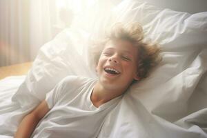 A boy happily wakes up in white bedroom photo