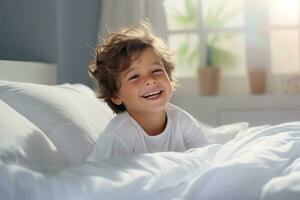 A boy happily wakes up in white bedroom photo