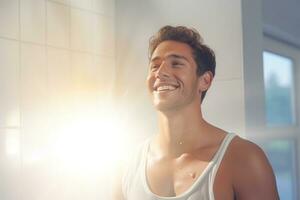 Smiling man taking a shower in a white bathroom photo