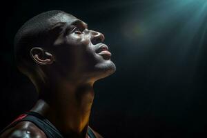 Male basketball player playing basketball in a crowded indoor basketball court photo