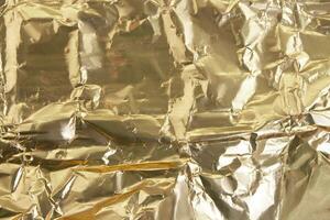 Gold shiny gradient crumpled background. Abstract foil. Holiday, wealth photo