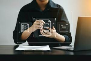 E-document management Paperless workplace, e-signing, electronic signature, document management. businessman signs an electronic document on a virtual notebook screen using a stylus pencil. photo