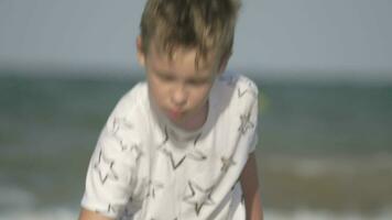 Child playing with sand at the seaside video