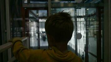 niño montando en moderno vidrioso ascensor video