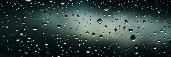 Heavy storm leaves intricate patterns of raindrops on a car windshield photo