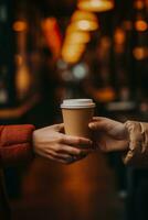 Close up of hands swapping takeaway coffee cups in an intimate exchange photo