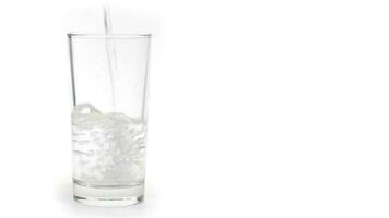 Glass of water with ice isolated on white background video