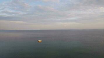 Flying over quiet sea with single boat video