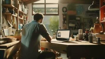 Focused man working from home on laptop in the sunny morning photo