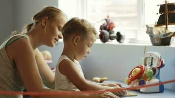 Mother and son playing learning game video