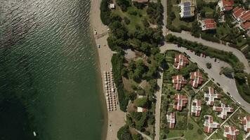 Aerial shot of resort town with cottages on sea coast, Greece video