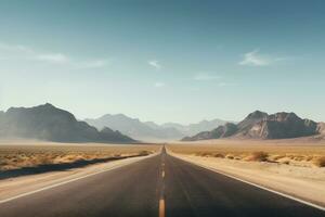 Straight road in the desert with mountain backdrop photo