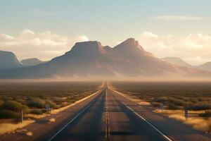 Straight road in the desert with mountain backdrop photo