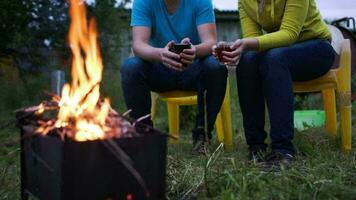 Couple having tea by fire in the evening video