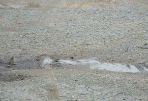 road surface with a lot of sand photo