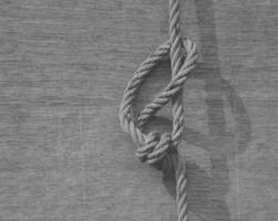 white rope knot on black and white background photo