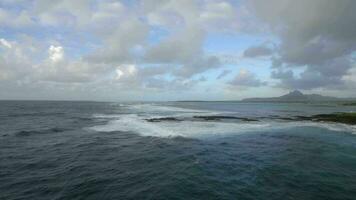 Aerial view of water line of seas that do not mix against blue sky with clouds, Mauritius Island video