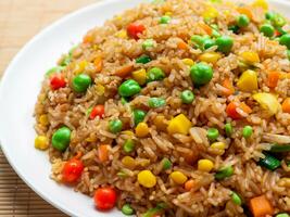 fried rice and vegetables on a white background photo