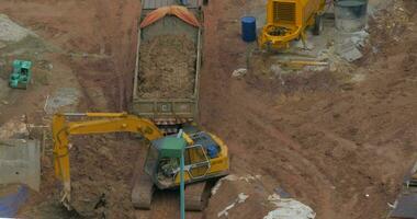 Excavator loading truck on construction site video