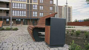 wooden bench with a garbage can next to the house video