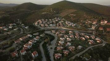 Aerial scene of neighbourhood and green hills in Trikorfo Beach, Greece video