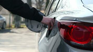 Closeup of man filling benzine gasoline fuel in car at gas station video