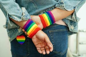 Asian woman with rainbow flag, LGBT symbol rights and gender equality, LGBT Pride Month in June. photo