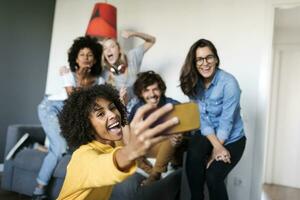 Cheerful friends taking a selfie at home photo