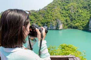 Woman tourist taking photos of Thale Nai