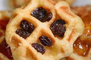 Close up fresh waffles with above dried raisins photo