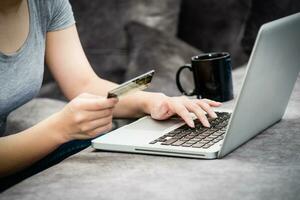 Woman holding credit card shopping online photo