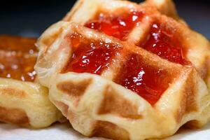 Close up fresh waffles with above strawberry jam photo