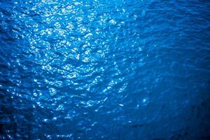 Blue turquoise water surface texture of the sea photo