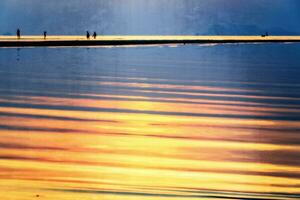 Vintage style silhouette of people on the beach photo