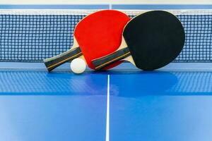 Black and red table tennis paddle with a net photo