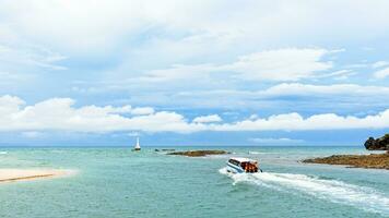 Speed boat is leaving the coast of Tarutao island photo